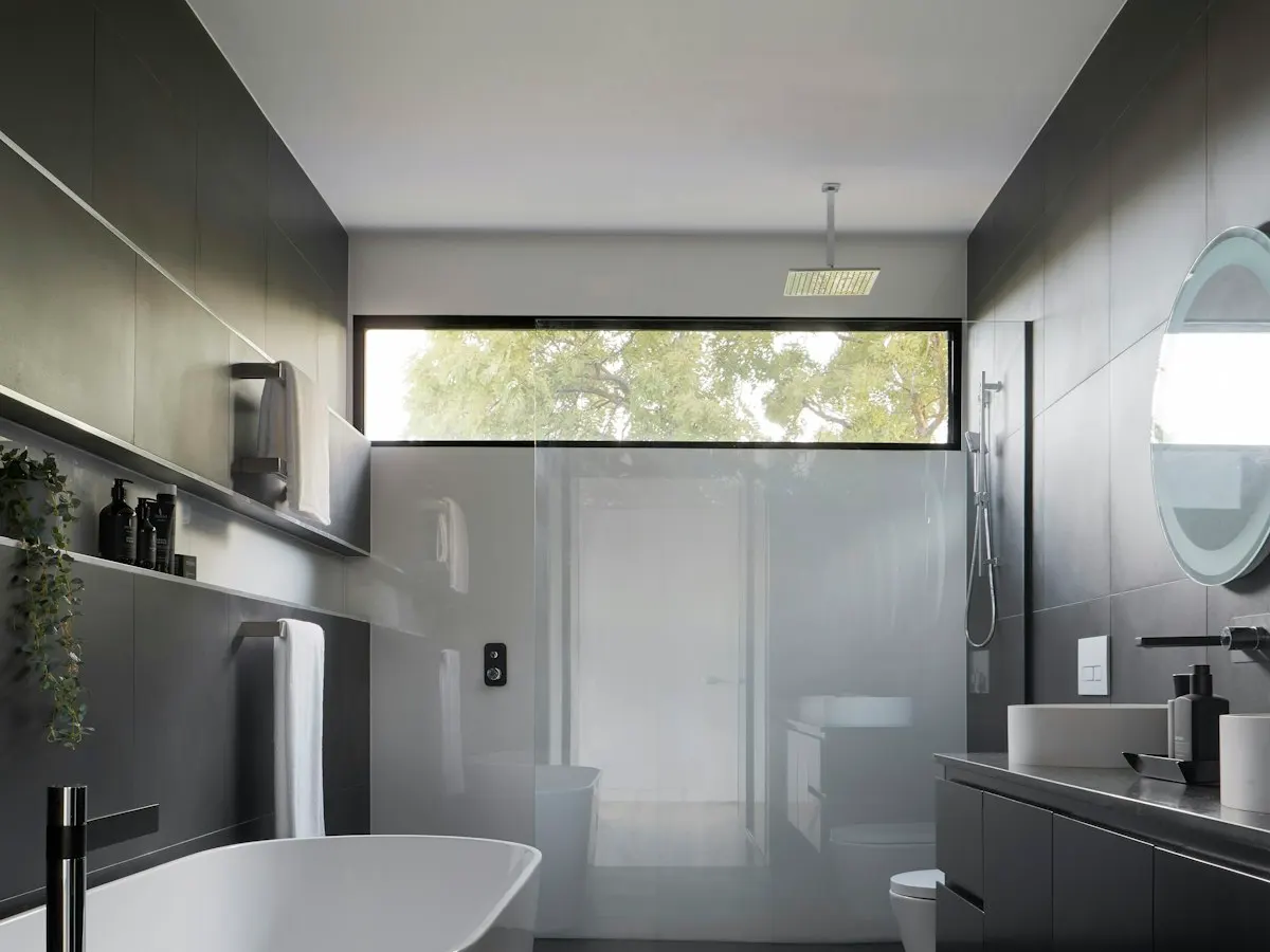 Modern dark-tiled bathroom after renovation